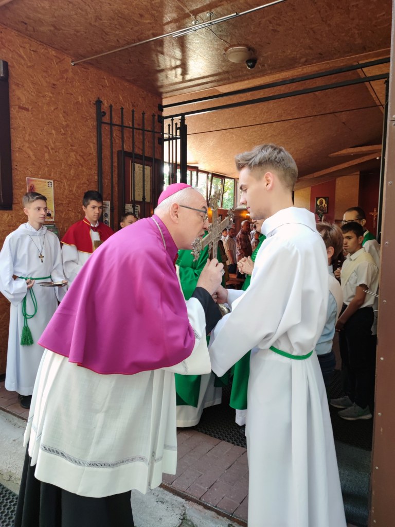Biskup całujący krzyż